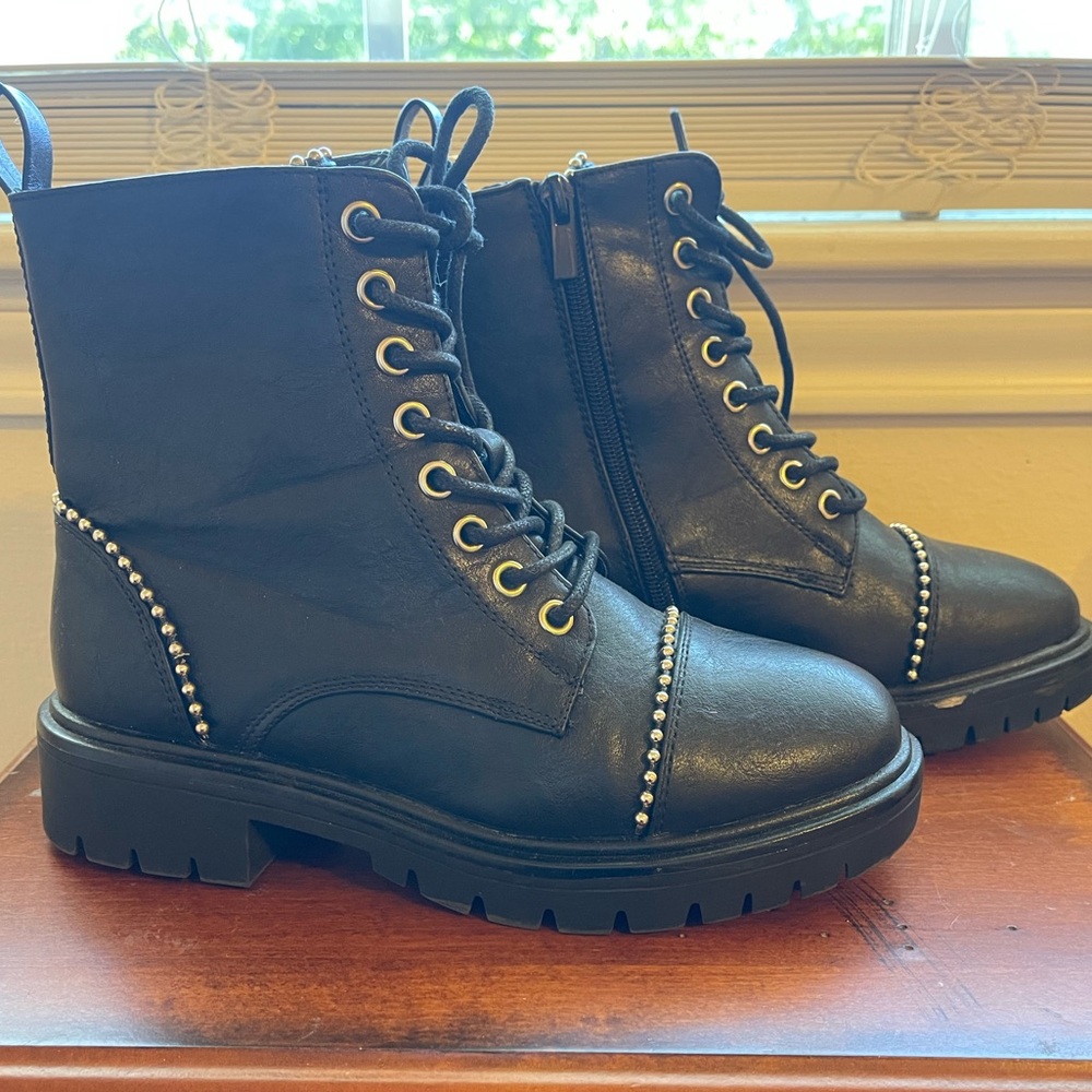 Women’s black combat boots with silver lining